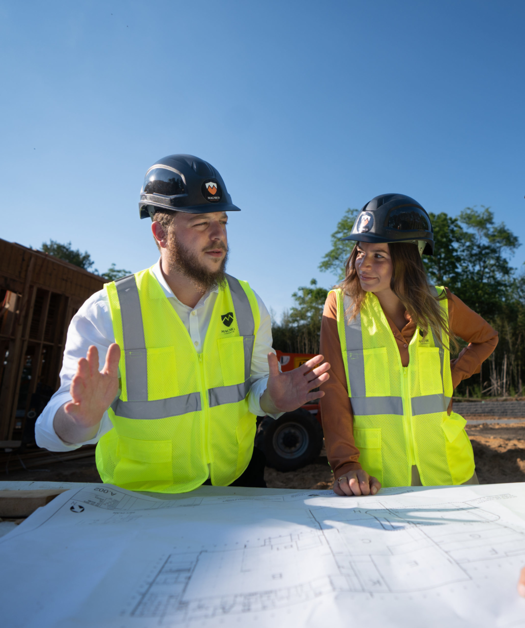 2 people looking at construction plans