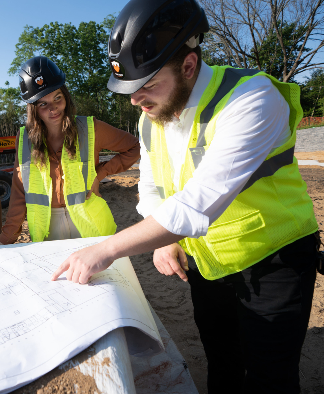 2 people looking at construction plans